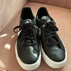 Black leather Nikes